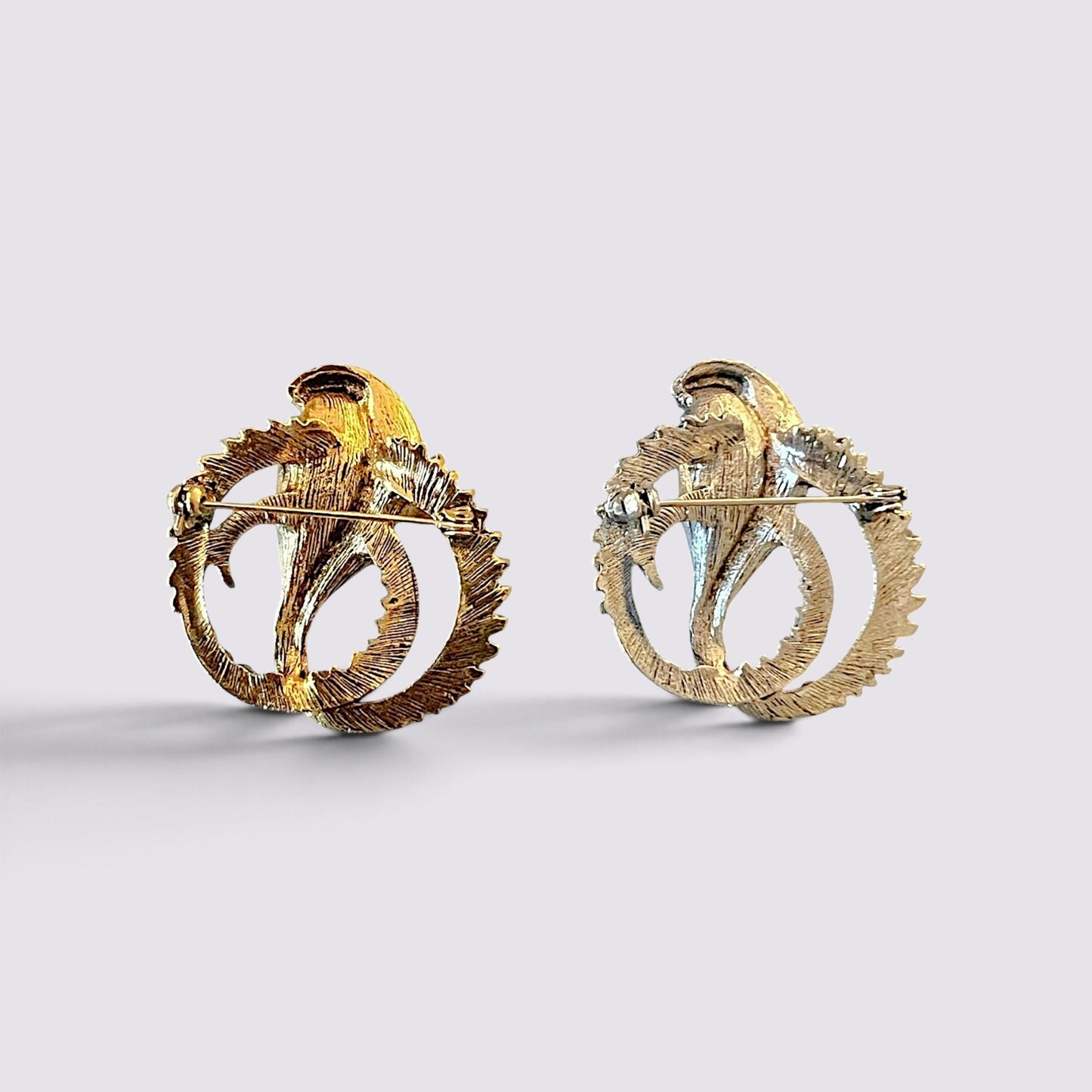 The Fashion Jewels cobra serpent statement brooch pins in gold and silver tones with detailed textured metal finish.