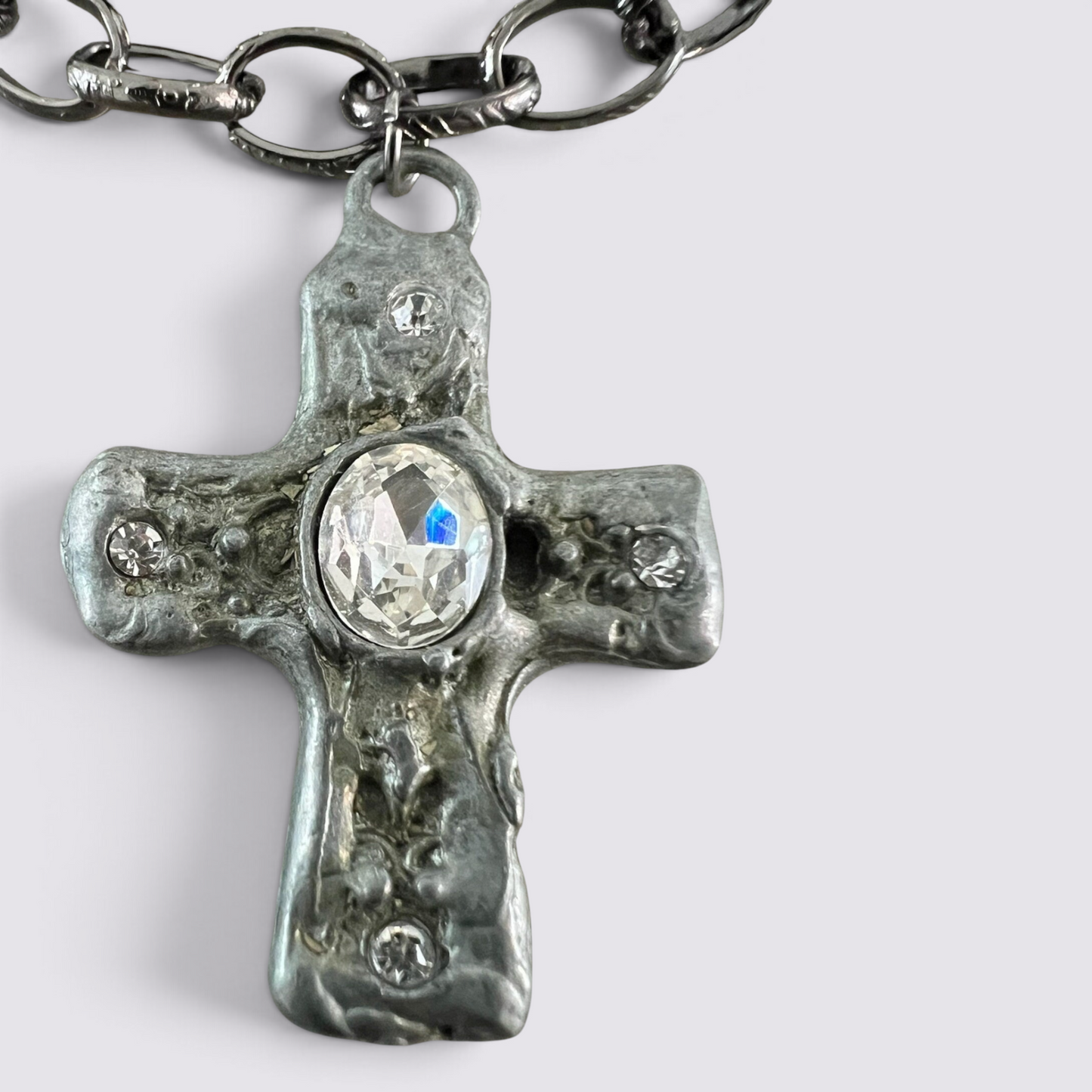 The Fashion Jewels layered necklace set featuring a textured dark metal cross pendant with clear crystal accents