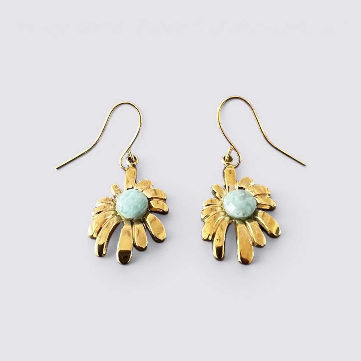 The Fashion Jewels gold-tone floral drop earrings featuring a faceted green stone center and hook-style backings.
