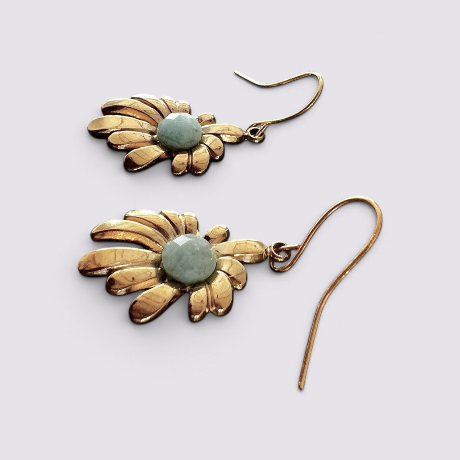 The Fashion Jewels floral drop earrings featuring a polished gold-tone sunburst petal design and a faceted green stone.
