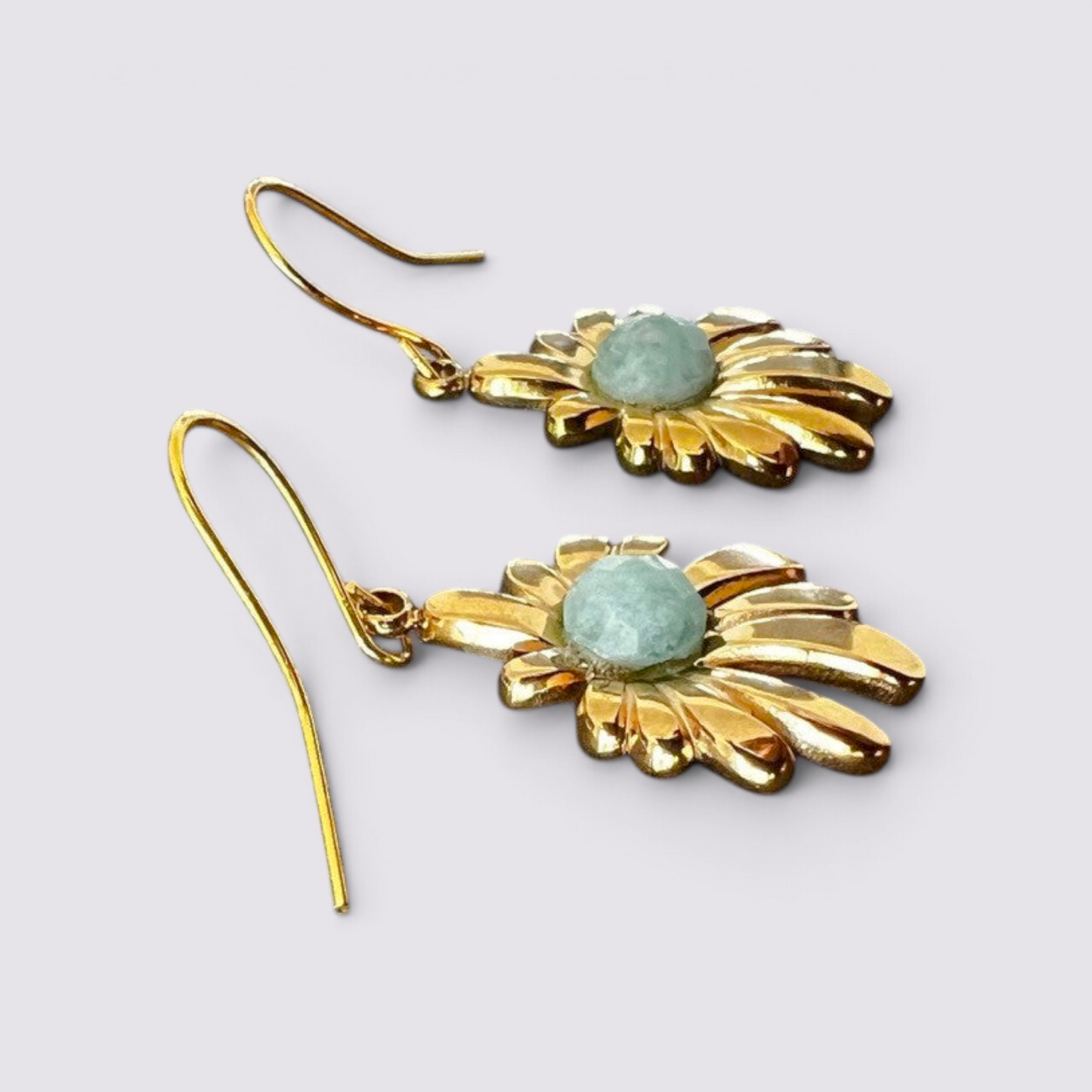 The Fashion Jewels floral drop earrings featuring polished gold-tone petals and a faceted green stone center.