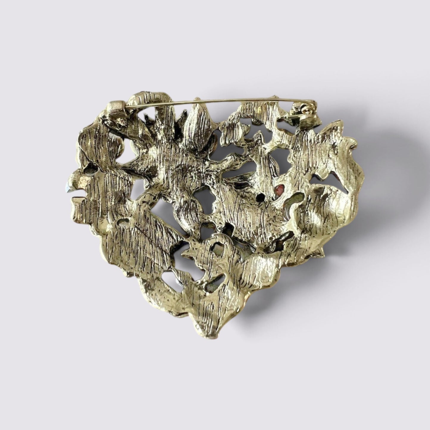 The Fashion Jewels heart-shaped brooch pin back view showing the antique metal finish and secure pin mechanism.