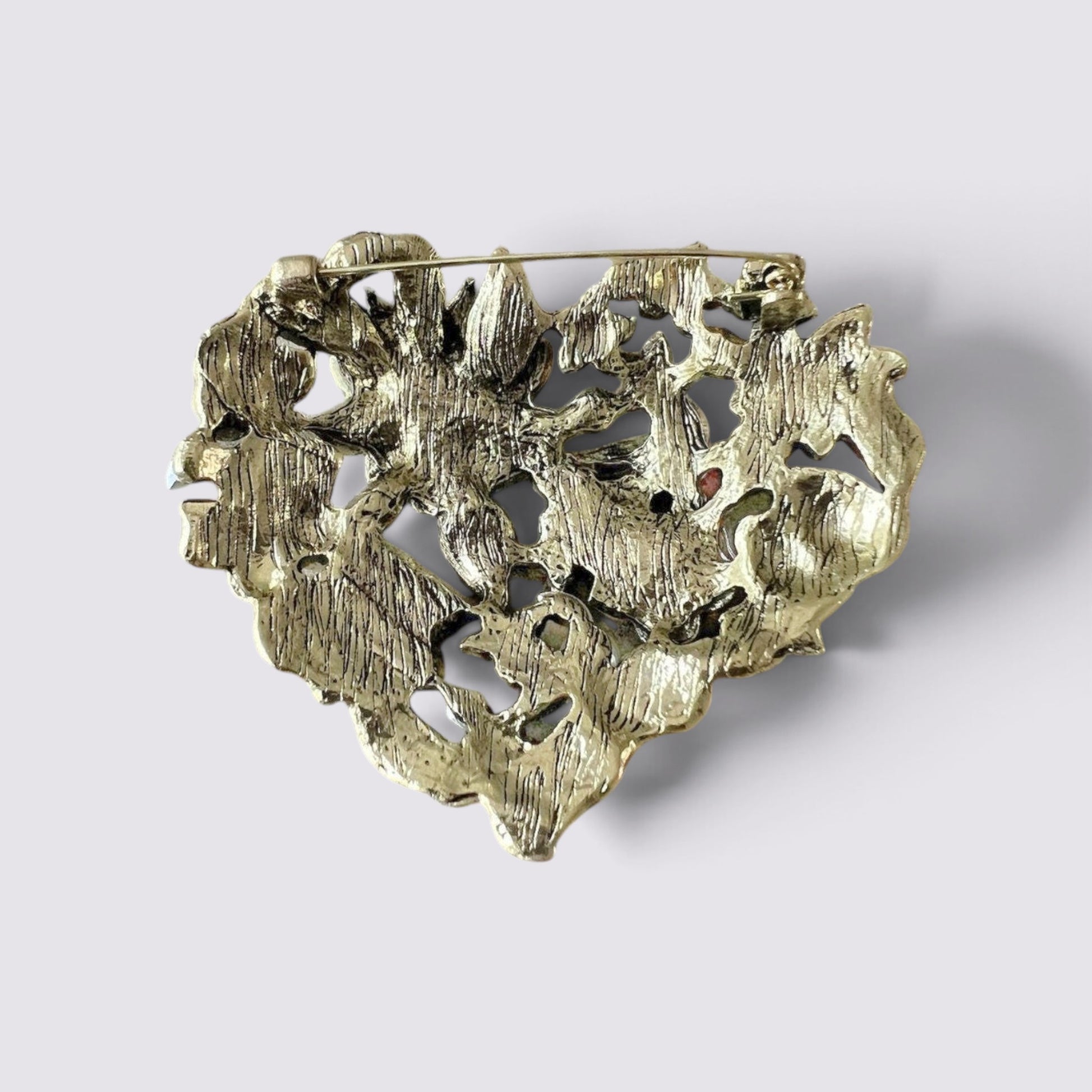 The Fashion Jewels heart-shaped brooch pin back view showing the antique metal finish and secure pin mechanism.