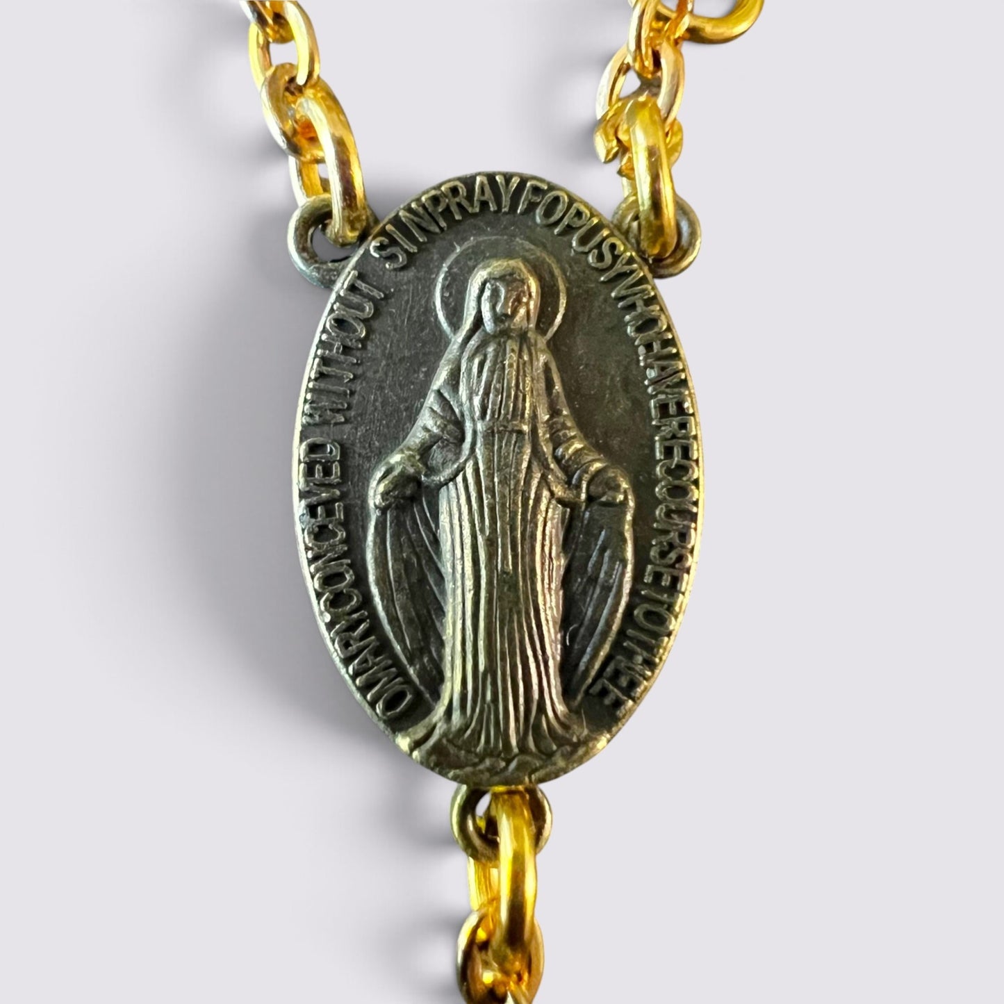 The Fashion Jewels rosary featuring an antique-finish Miraculous Medal centerpiece on a gold-toned chain.