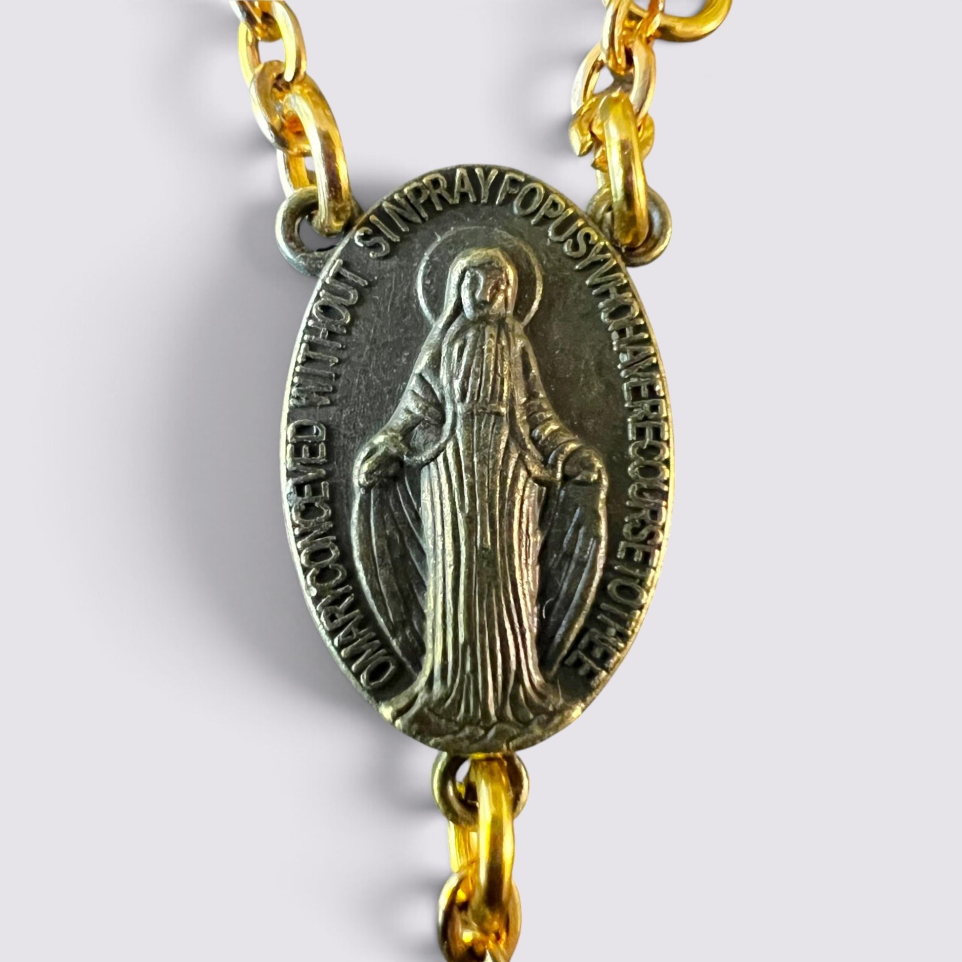 The Fashion Jewels rosary featuring an antique-finish Miraculous Medal centerpiece on a gold-toned chain.