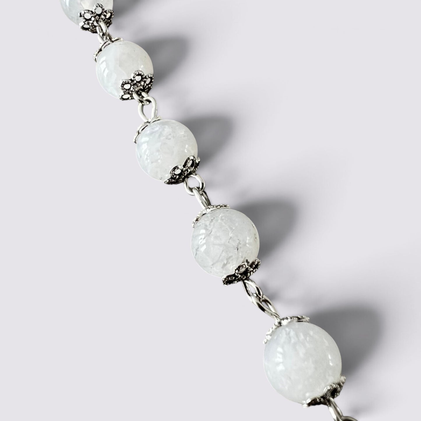 The Fashion Jewels handcrafted rosary featuring luminous moonstone beads with intricate vintage silver-tone metal caps.