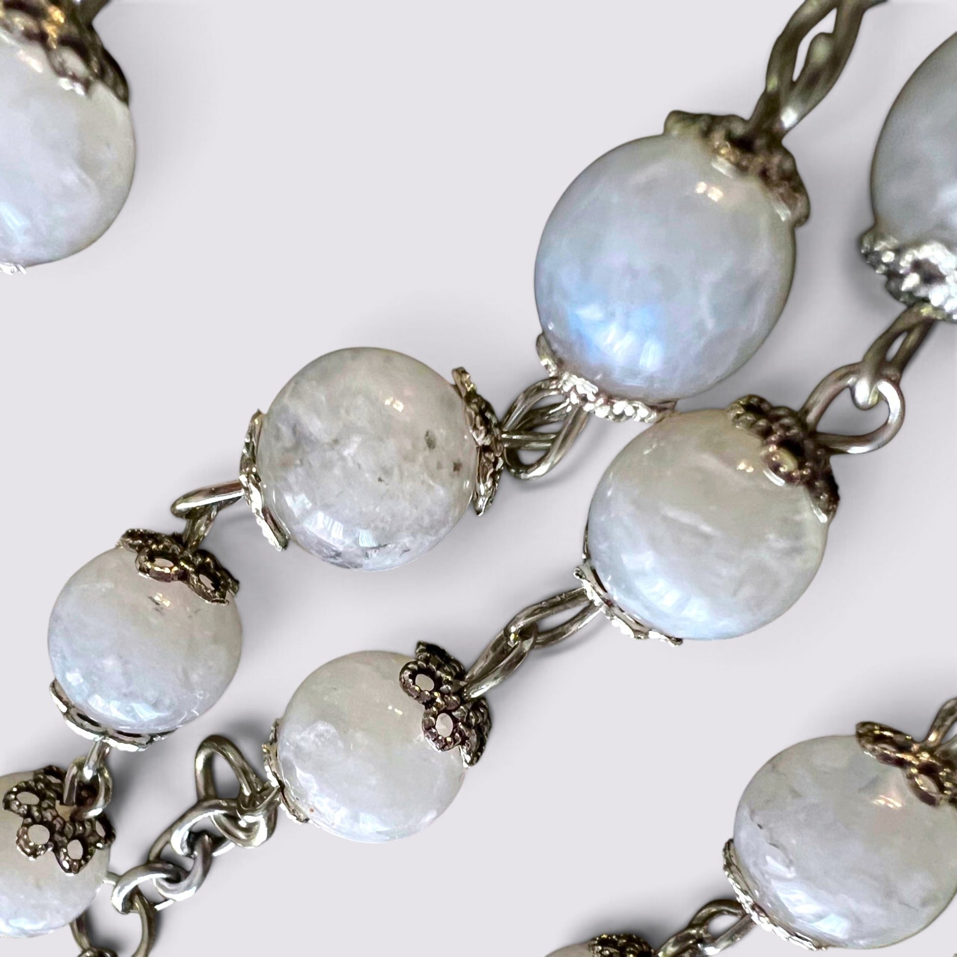 The Fashion Jewels handcrafted rosary featuring luminous moonstone beads with intricate silver-tone vintage bead caps.