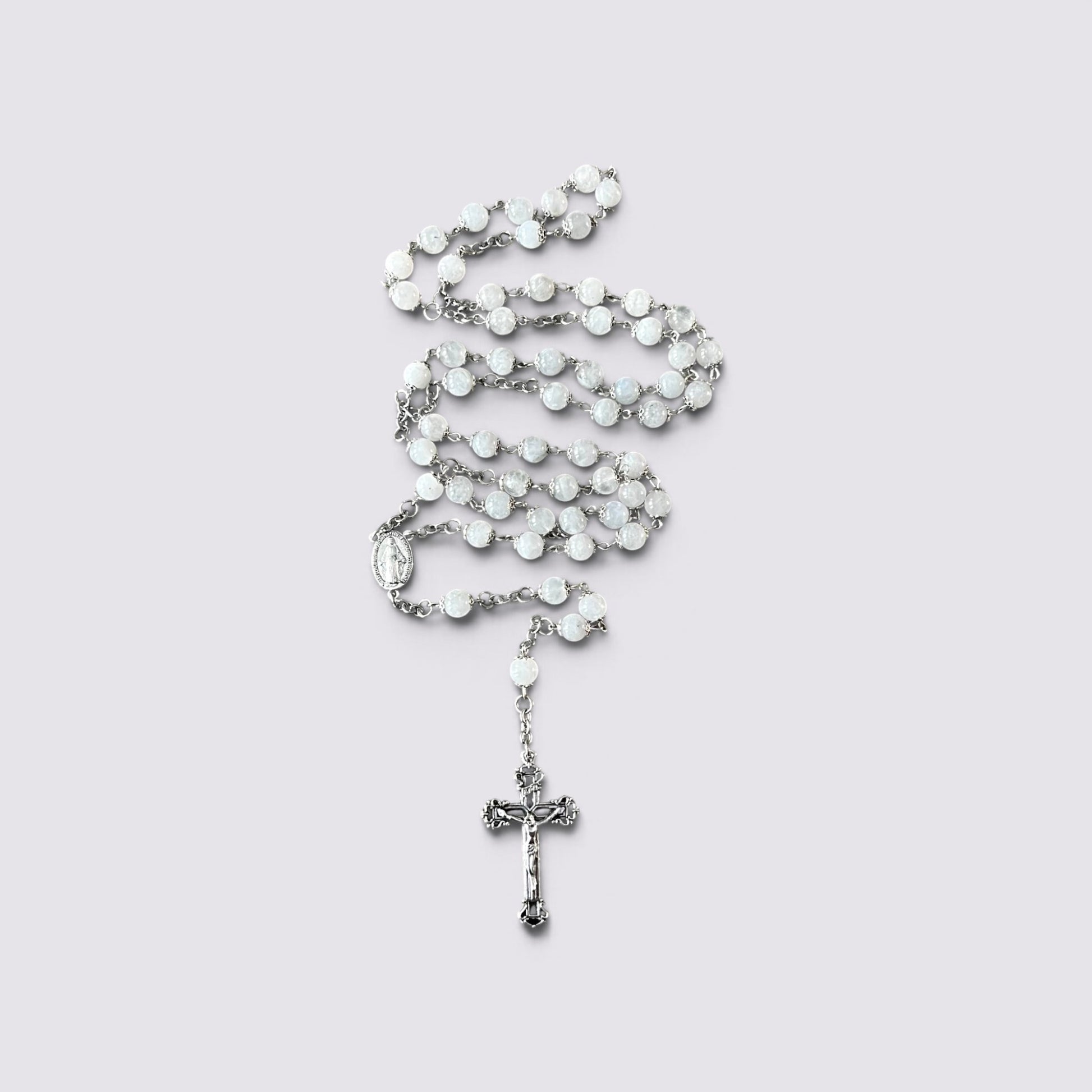 The Fashion Jewels handcrafted rosary featuring luminous moonstone beads, silver-tone metalwork, and an ornate crucifix.