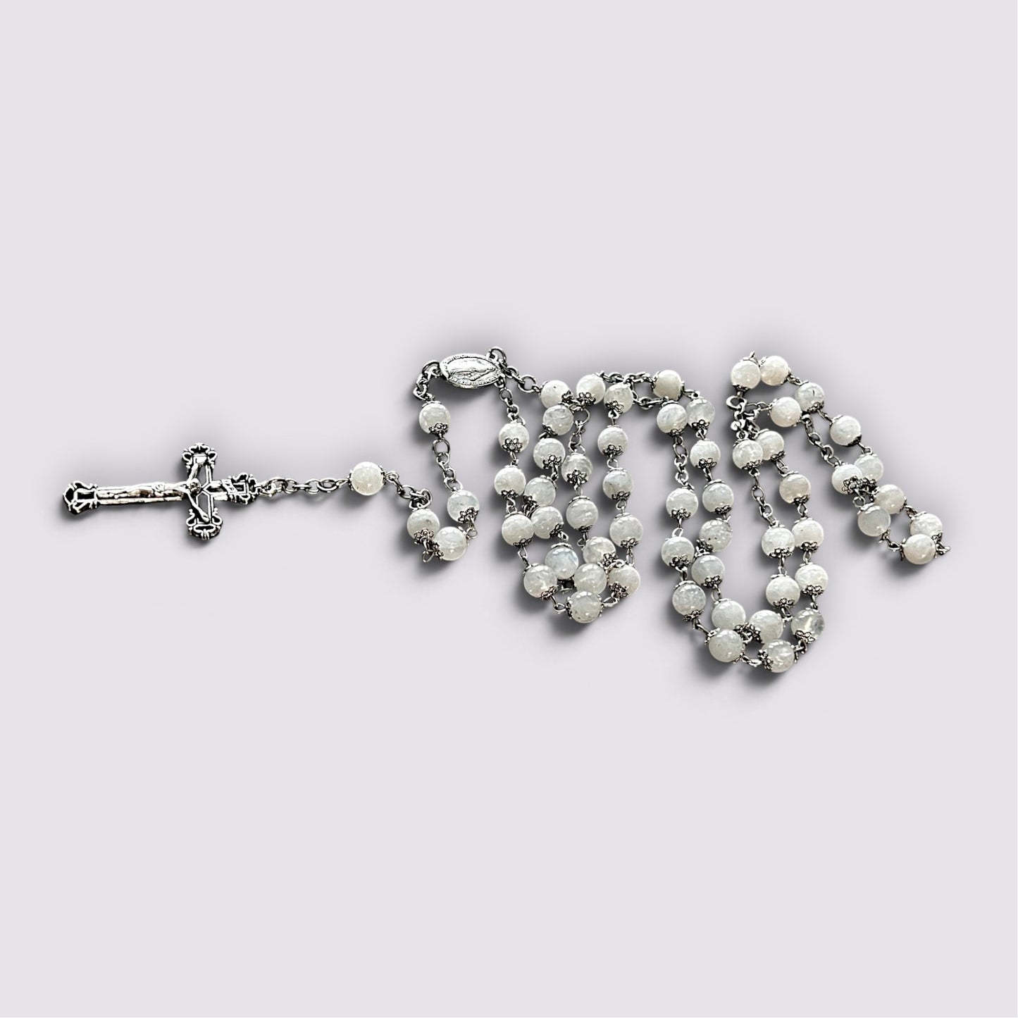 The Fashion Jewels handcrafted rosary featuring luminous moonstone beads, silver-tone metalwork, and ornate crucifix.