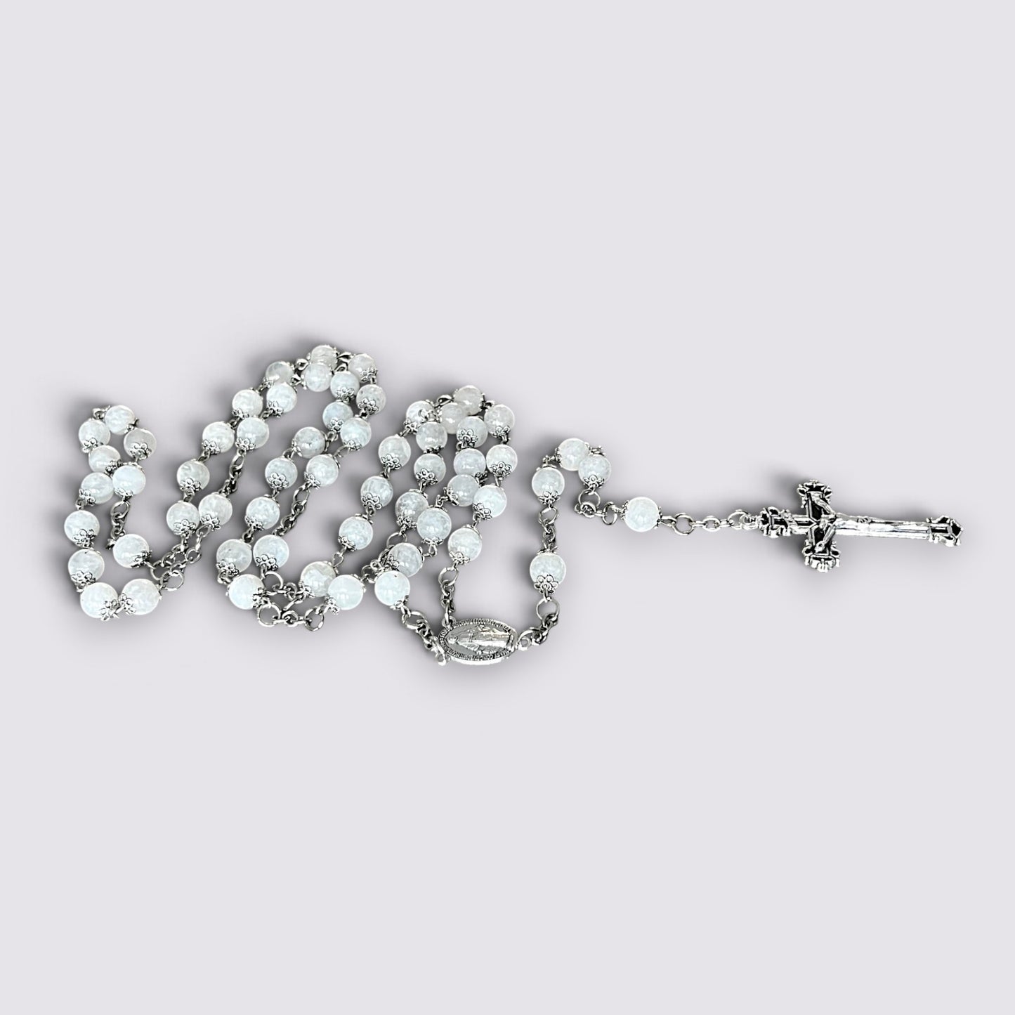 The Fashion Jewels handcrafted rosary featuring luminous moonstone beads, silver-tone metalwork, and an ornate crucifix.