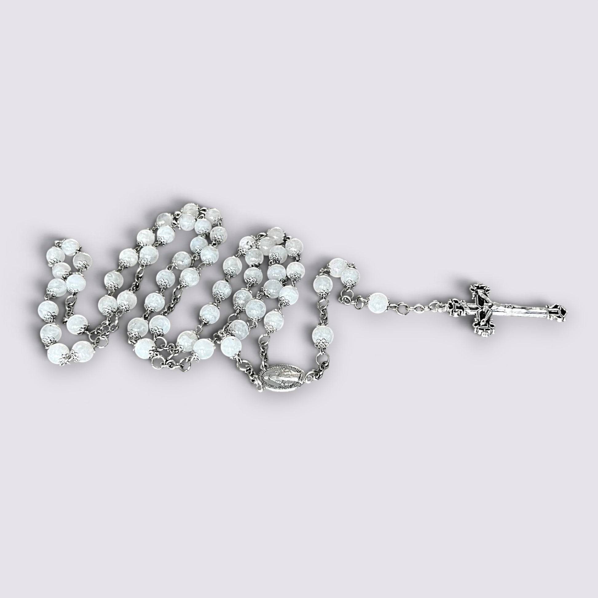 The Fashion Jewels handcrafted rosary featuring luminous moonstone beads, silver-tone metalwork, and an ornate crucifix.