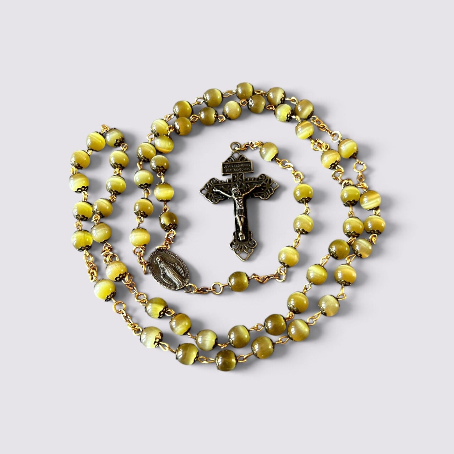 The Fashion Jewels olive cat's eye beaded rosary with antique-style metal crucifix and Miraculous Medal centerpiece.