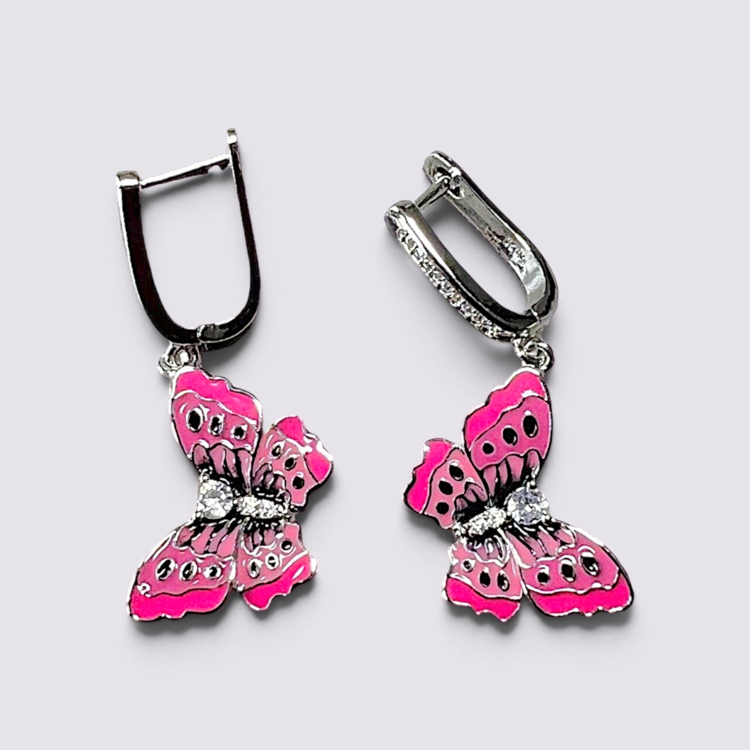 The Fashion Jewels pink enameled butterfly drop earrings with sparkling crystal accents and secure lever back closures.