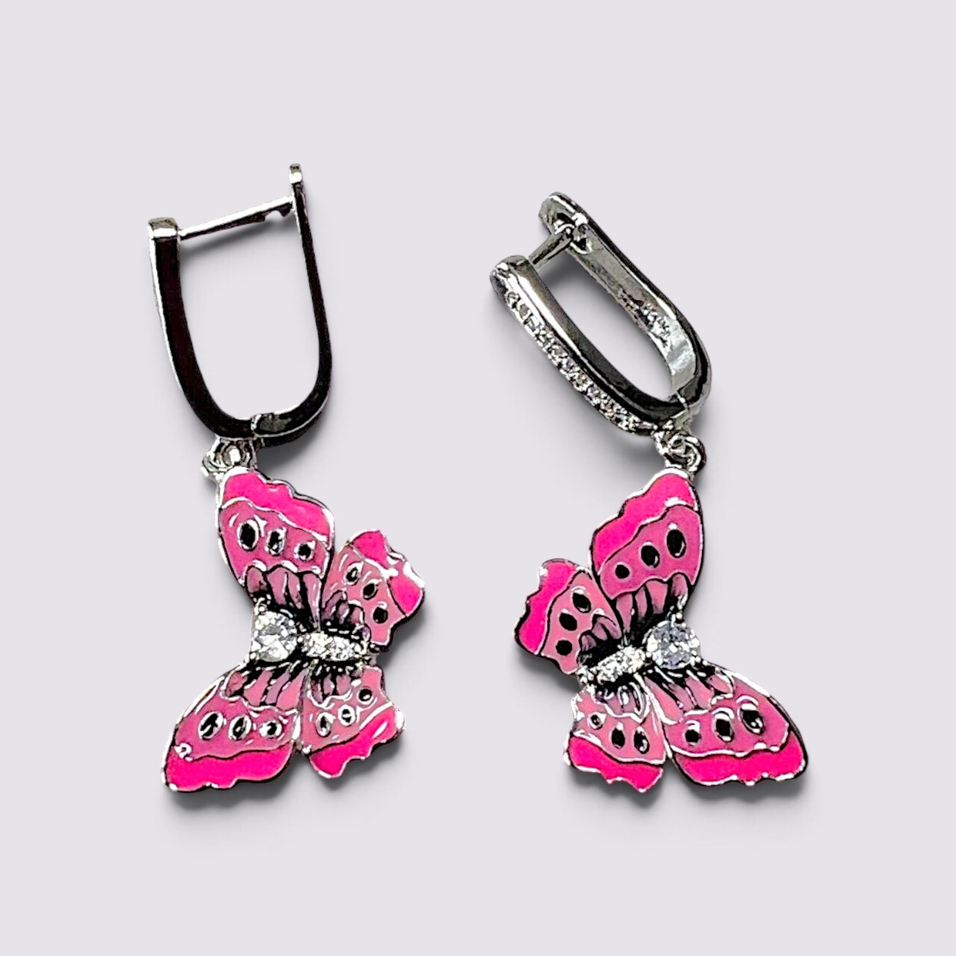 The Fashion Jewels pink enameled butterfly drop earrings with sparkling crystal accents and secure lever back closures.