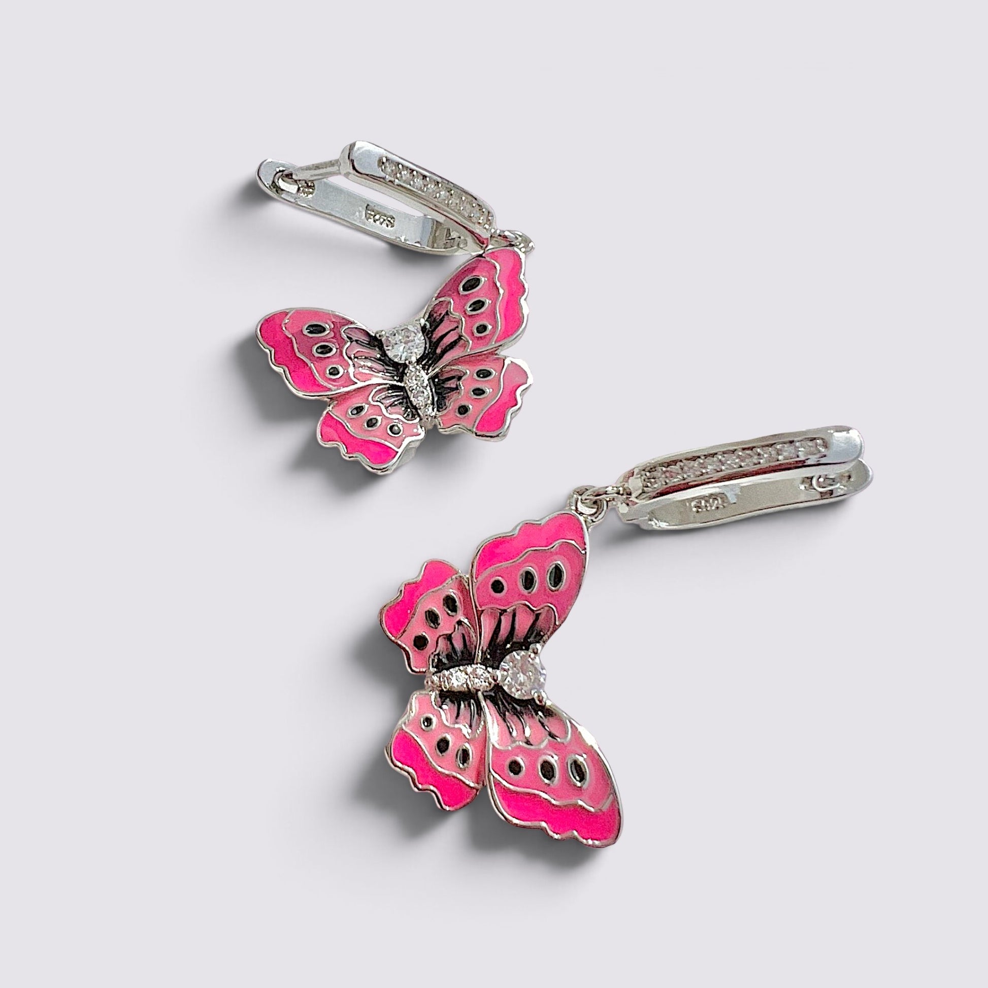 The Fashion Jewels pink enameled butterfly drop earrings with sparkling accents and polished silver-tone metal finish