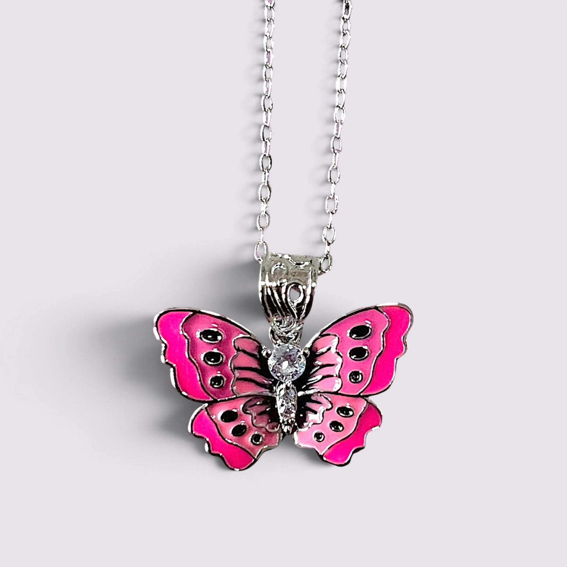 The Fashion Jewels pink enameled butterfly pendant necklace with clear stone accents on a silver-tone chain.