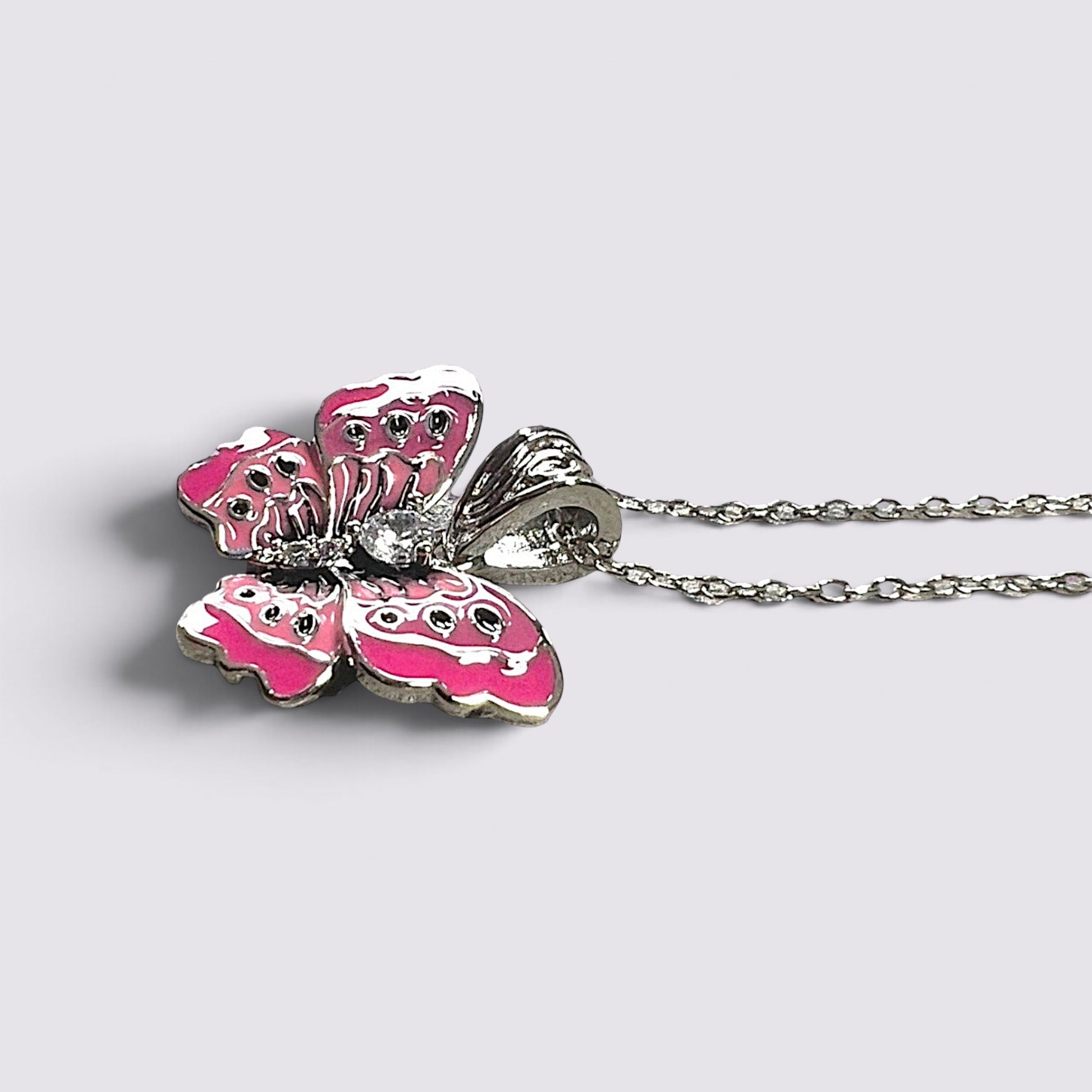 The Fashion Jewels pink enameled butterfly pendant necklace with sparkling clear stones on a silver-tone chain.
