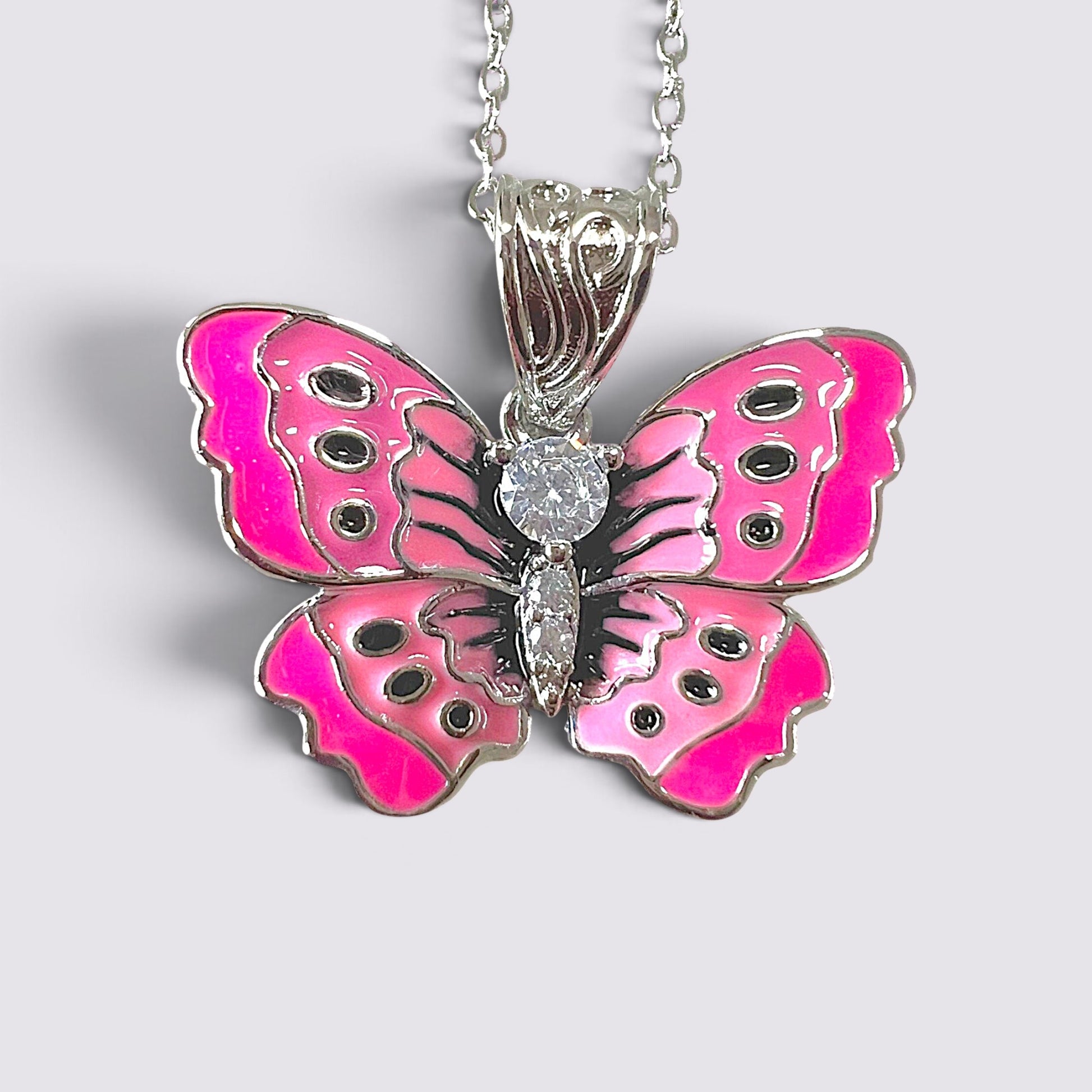 The Fashion Jewels pink enameled butterfly pendant necklace with clear stone accents on a silver-tone chain.