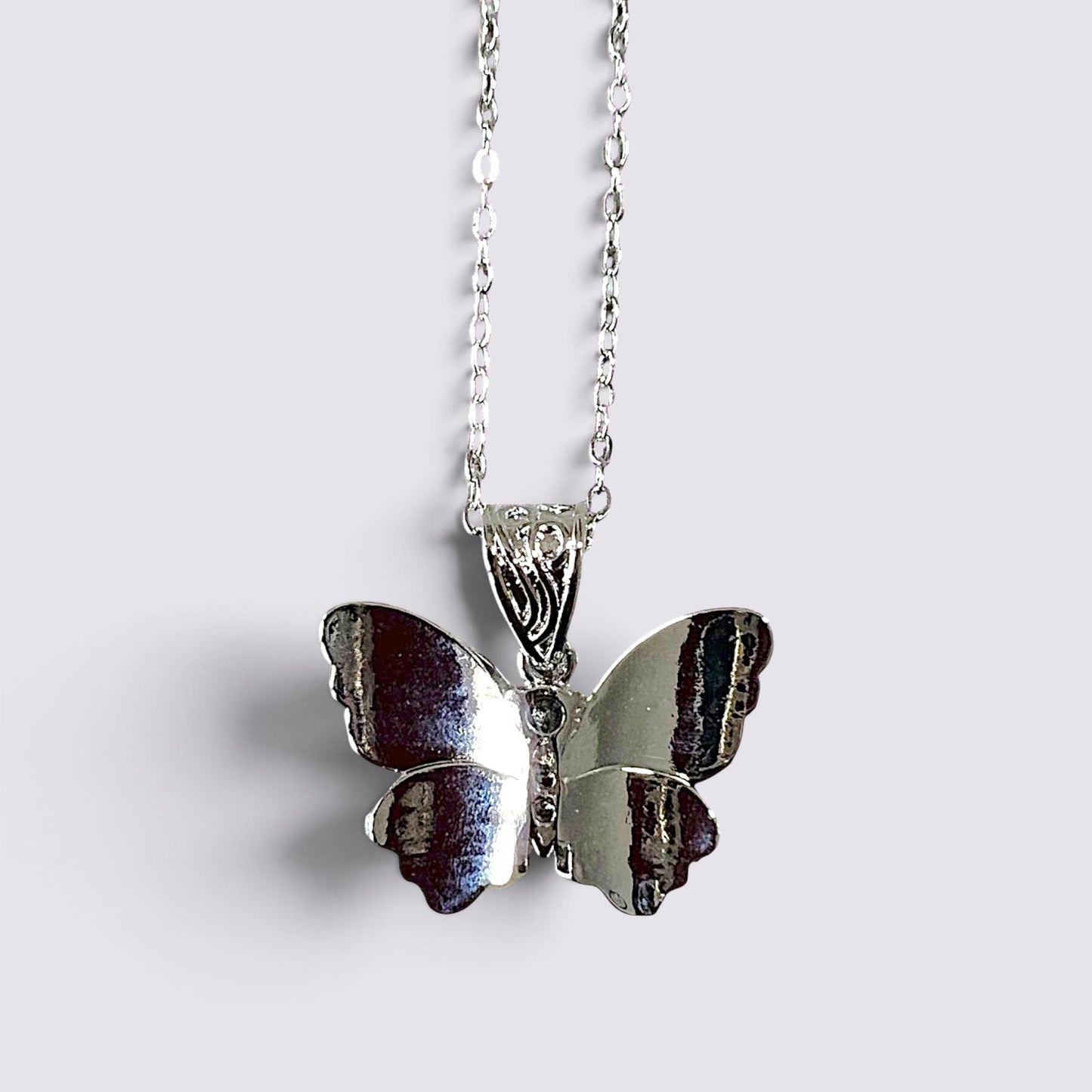 The Fashion Jewels silver butterfly pendant necklace with a polished metallic finish on a delicate chain.