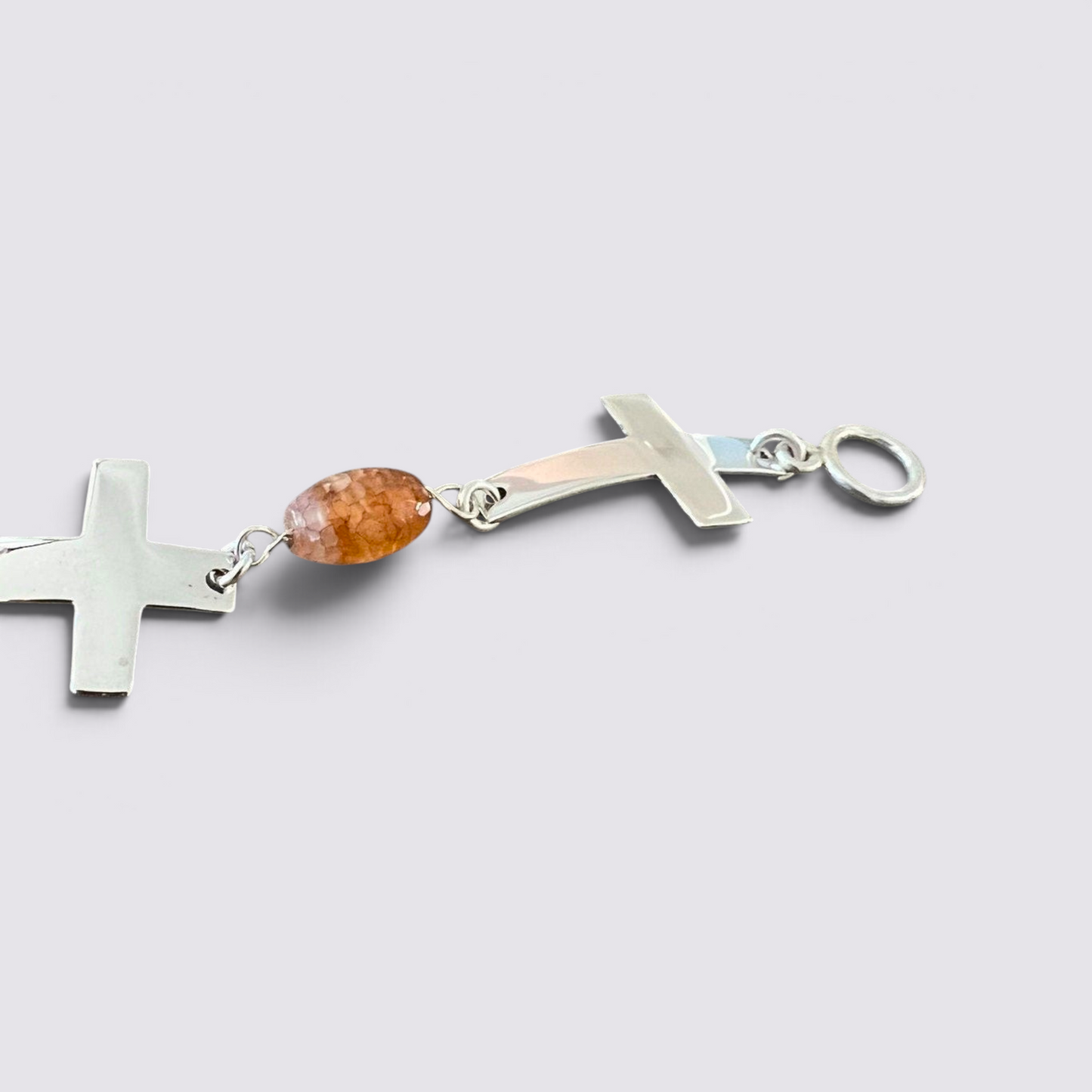 The Fashion Jewels sterling silver cross bracelet with faceted orange carnelian beads and a toggle clasp.