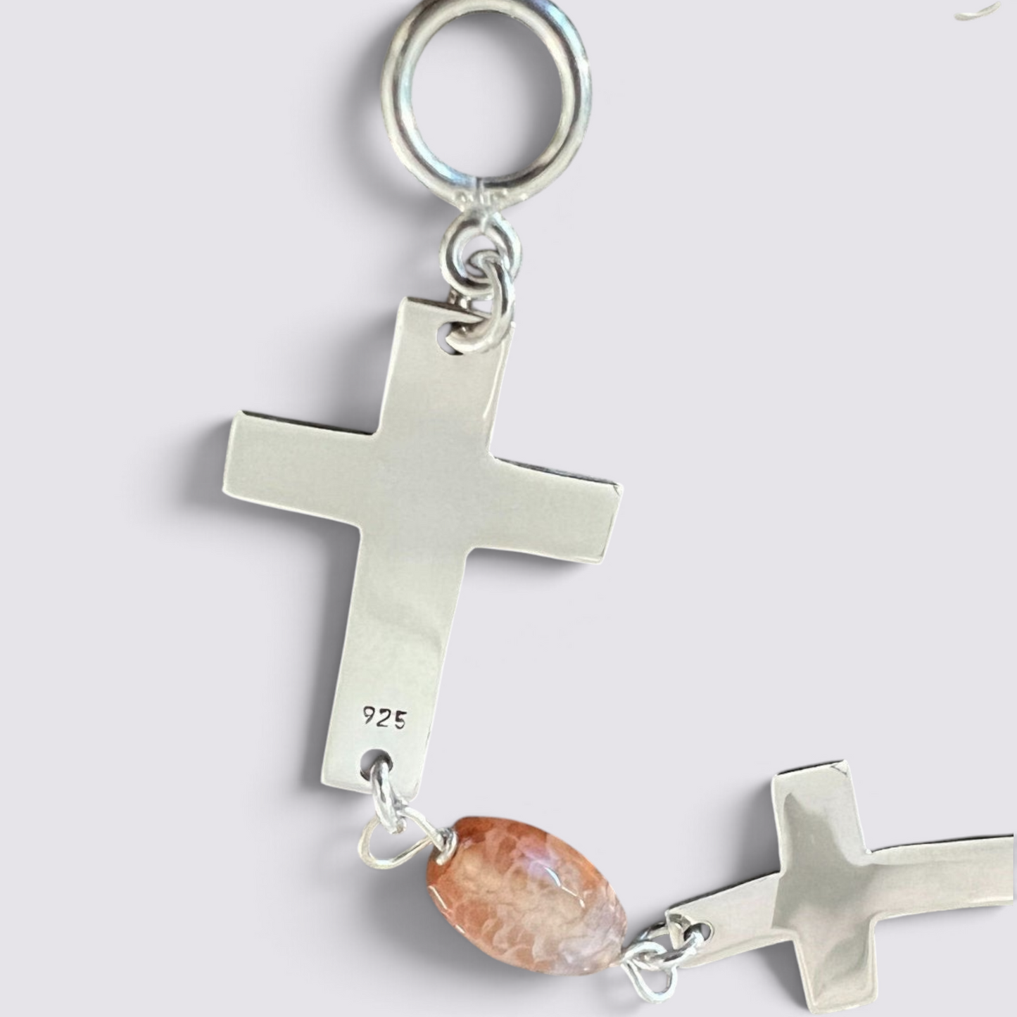 The Fashion Jewels sterling silver cross bracelet featuring polished 925 silver crosses and faceted carnelian beads.