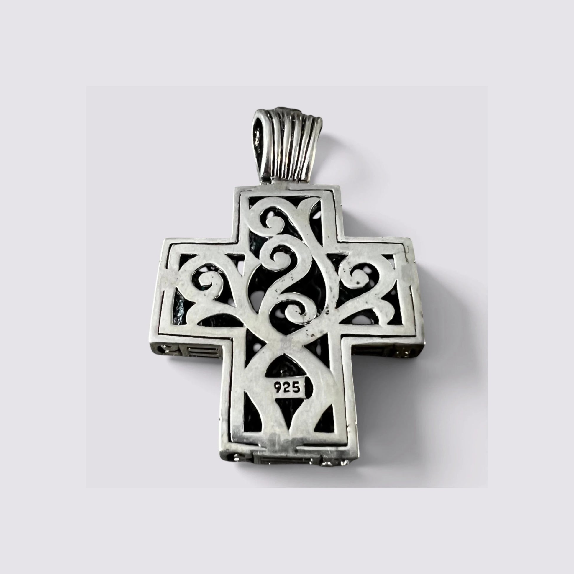 The Fashion Jewels sterling silver cross pendant back view showing 925 hallmark and intricate scrollwork engraving.