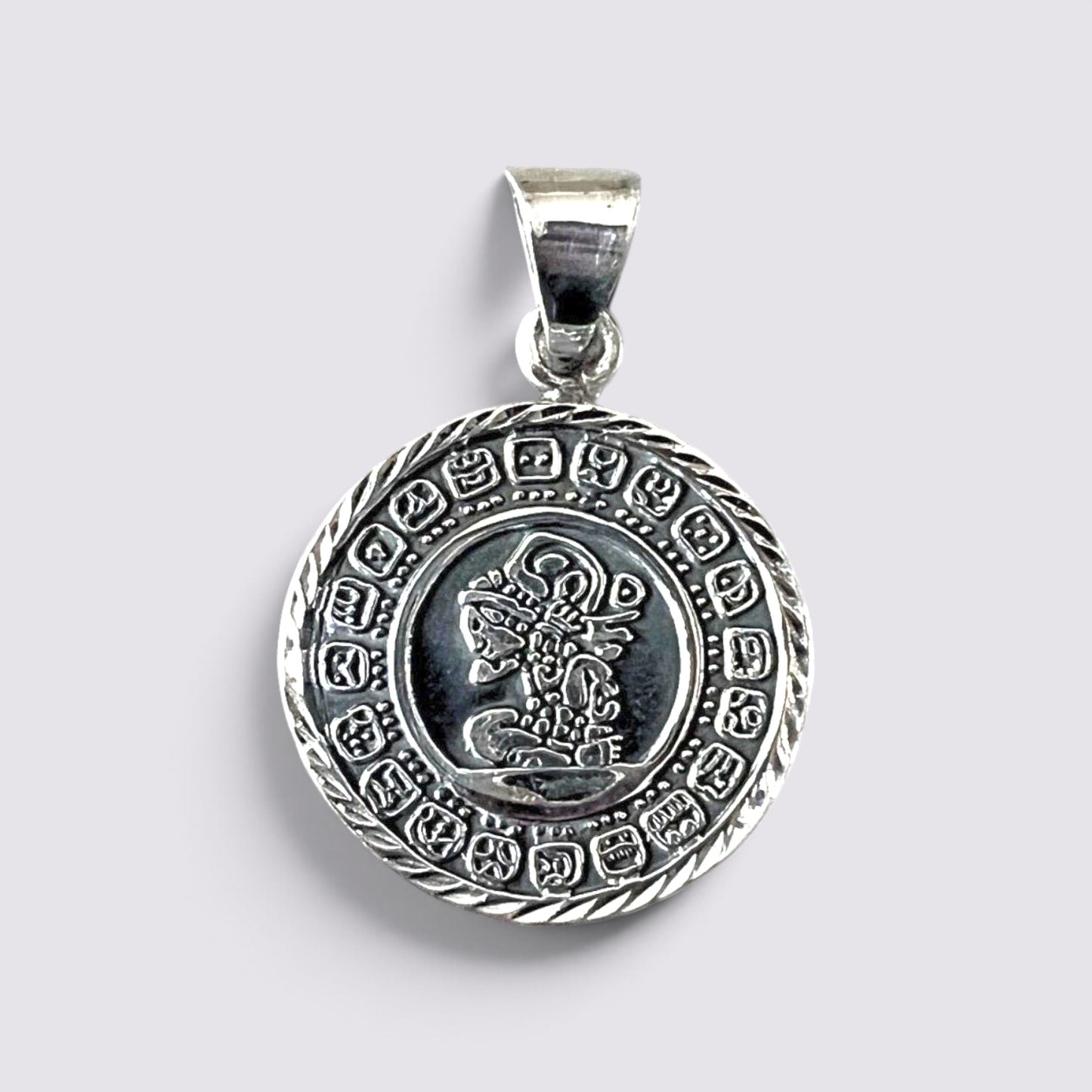 The Fashion Jewels handmade silver Mayan calendar pendant featuring intricate circular Aztec-inspired engravings.