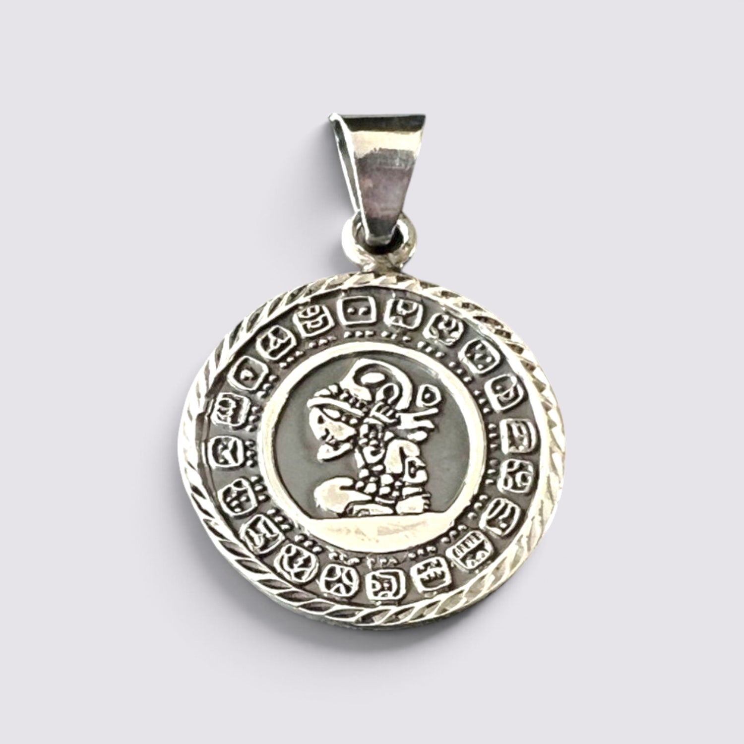 The Fashion Jewels handmade silver Mayan calendar pendant featuring intricate circular Aztec-inspired engravings.