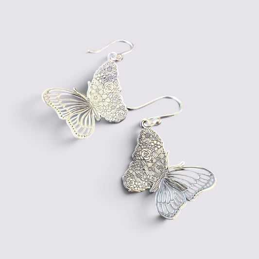 The Fashion Jewels sterling silver butterfly drop earrings with intricate floral wing detailing and hook backings.