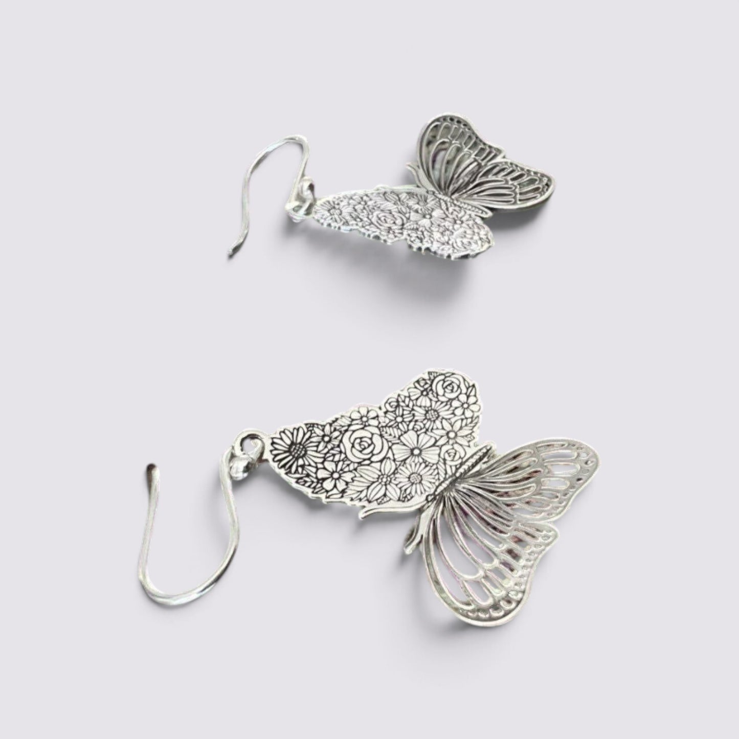 The Fashion Jewels sterling silver butterfly drop earrings with intricate floral wing etchings and hook backings.