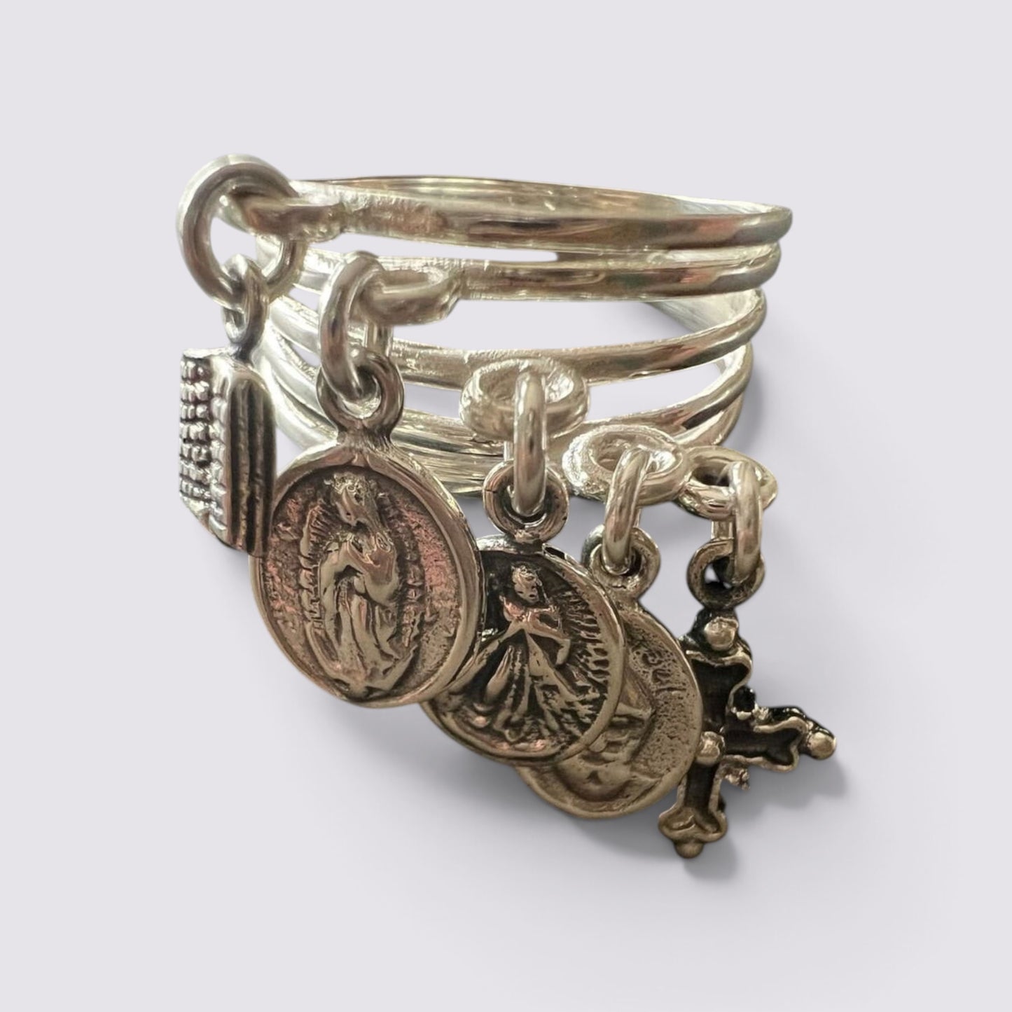 The Fashion Jewels sterling silver ring featuring five hanging religious charms including a cross and saint medals