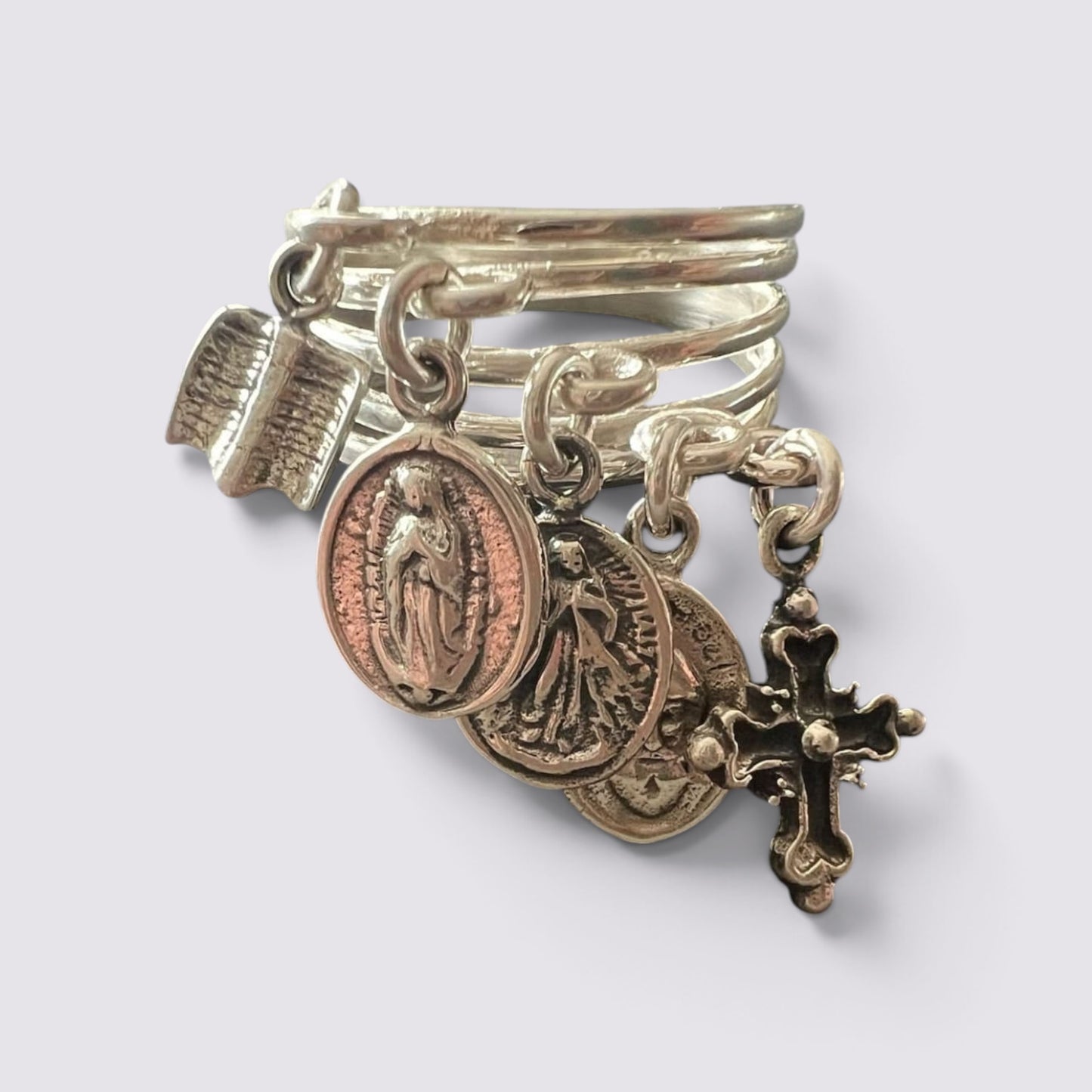The Fashion Jewels sterling silver ring featuring five hanging religious charms including a cross and saint medals.