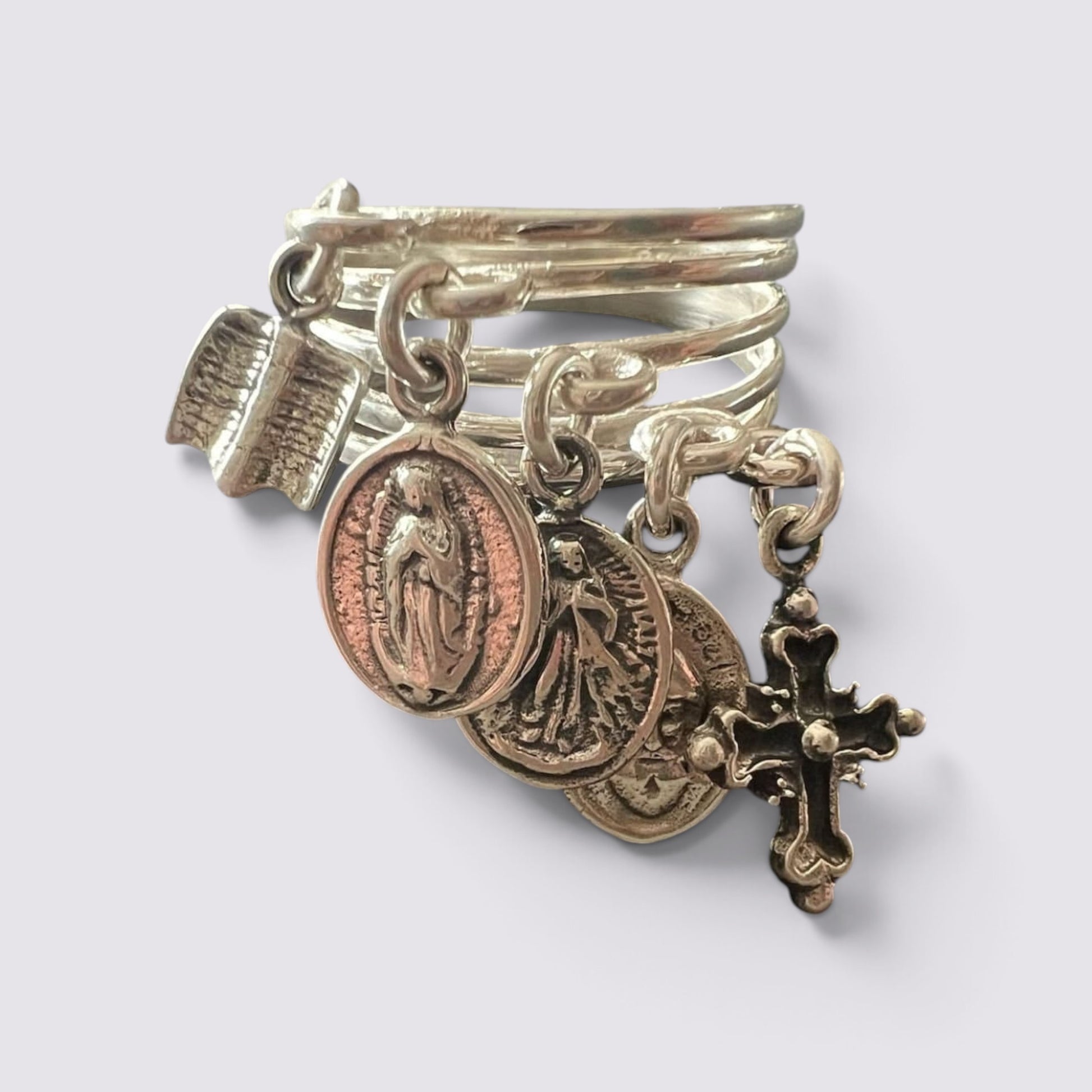 The Fashion Jewels sterling silver ring featuring five hanging religious charms including a cross and saint medals.