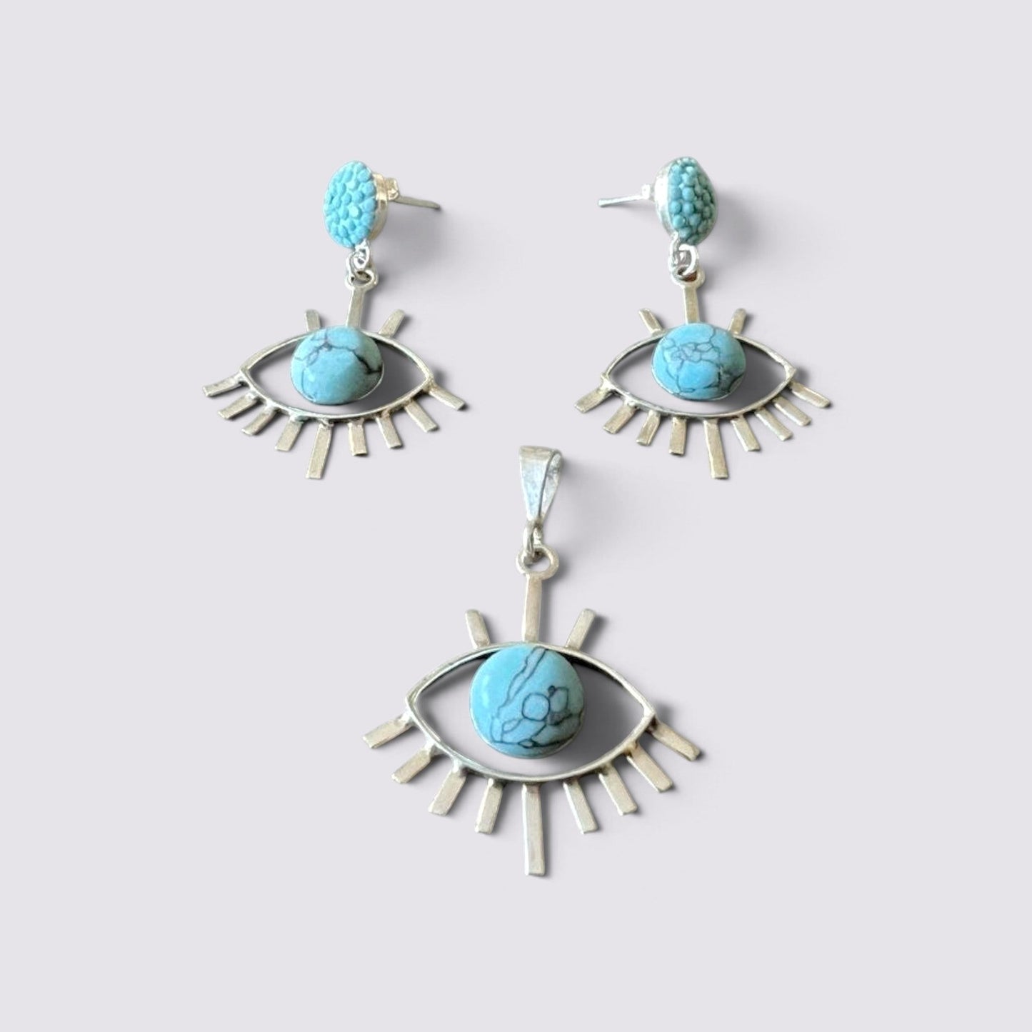 The Fashion Jewels sterling silver evil eye jewelry set with turquoise stones, featuring earrings and a pendant.