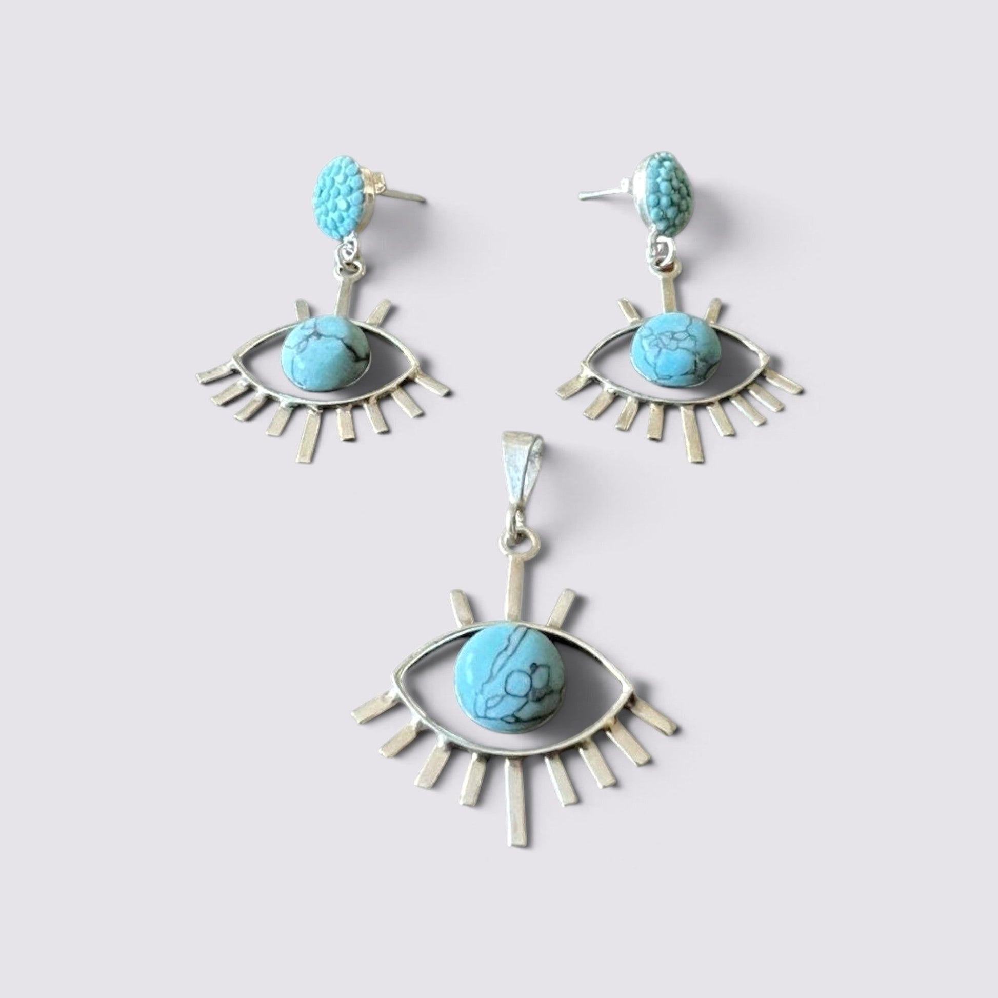 The Fashion Jewels sterling silver evil eye jewelry set with turquoise stones, featuring earrings and a pendant.