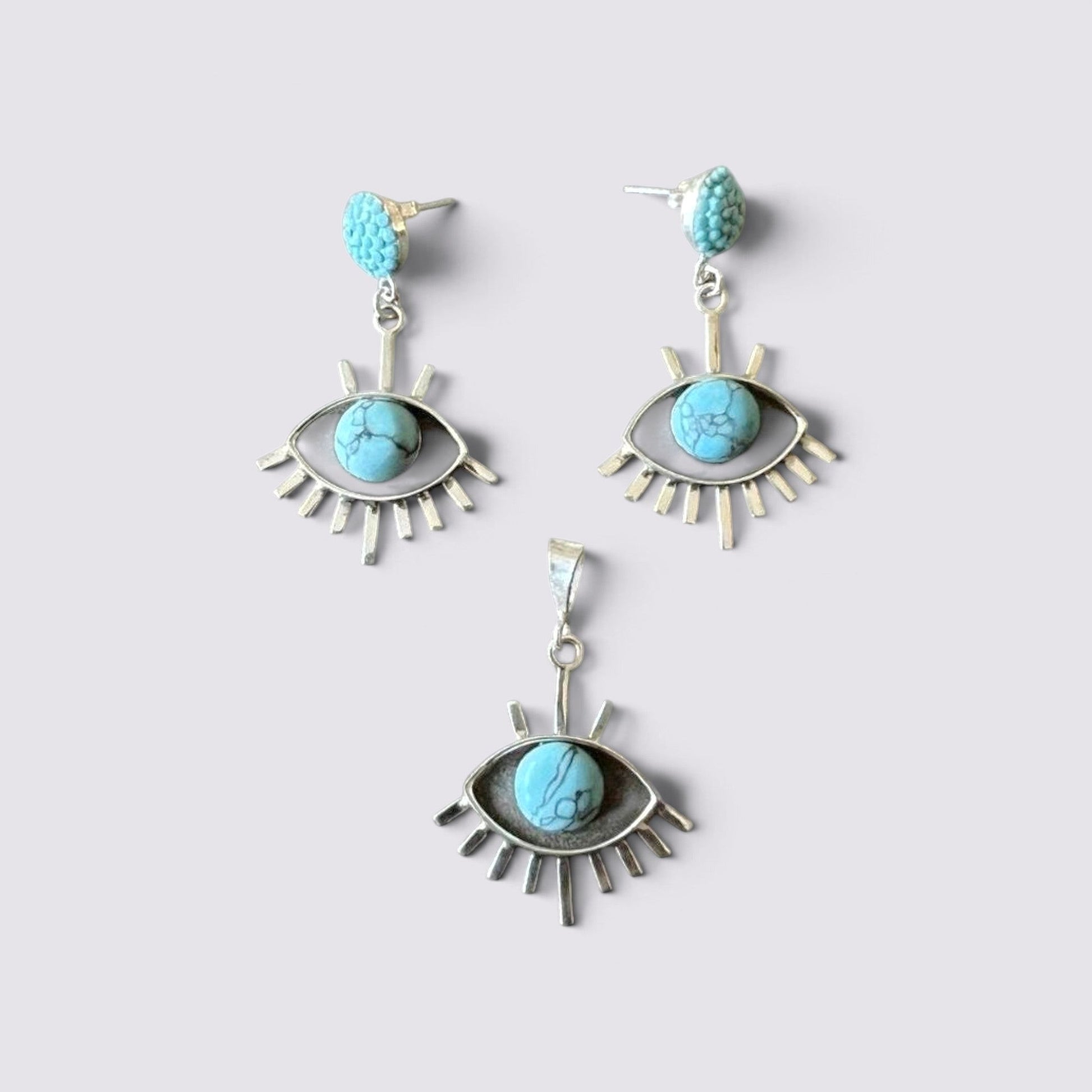 The Fashion Jewels sterling silver evil eye jewelry set featuring turquoise stones in earrings and a matching pendant.