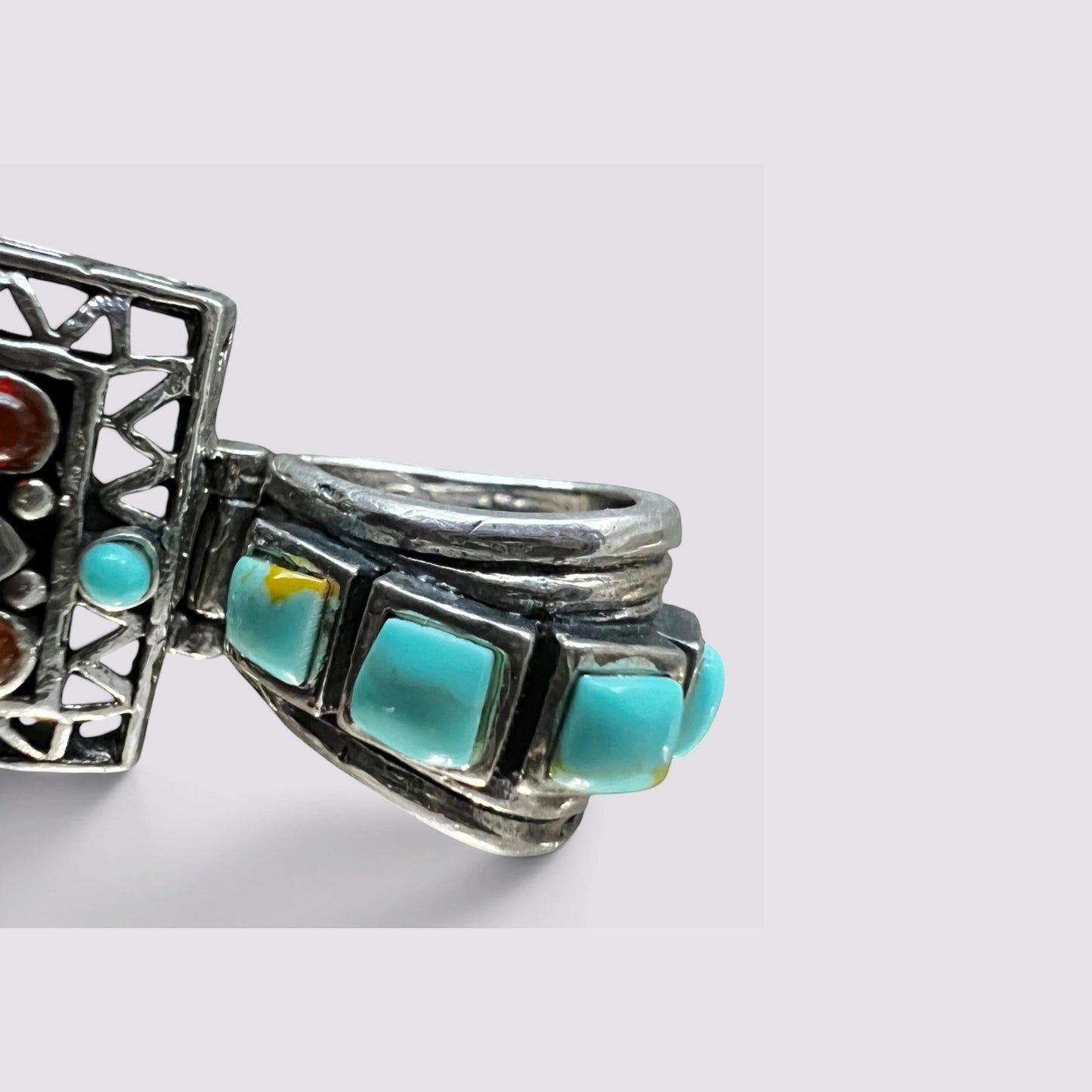 The Fashion Jewels sterling silver cross pendant featuring an ornate turquoise-inlaid bail and oxidized metal finish.