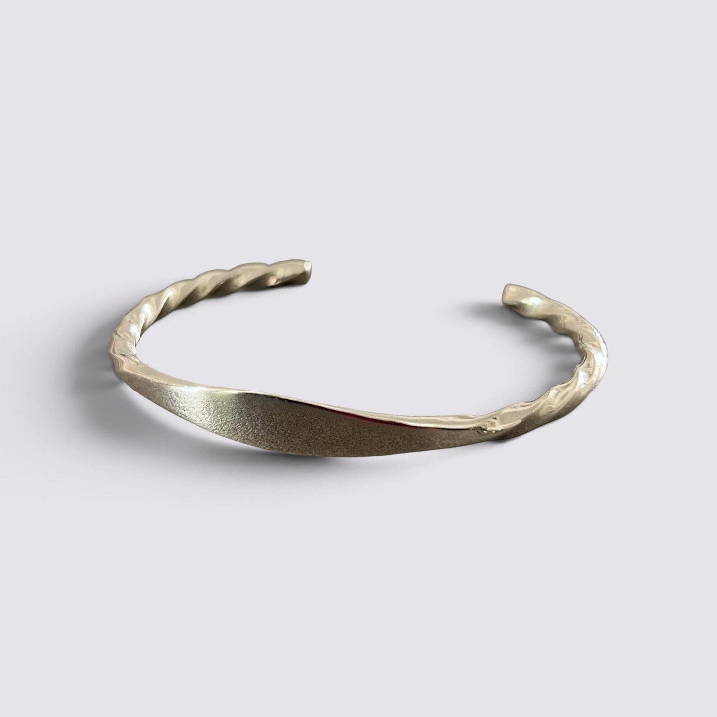 The Fashion Jewels sterling silver open cuff bracelet with a polished twisted metal texture