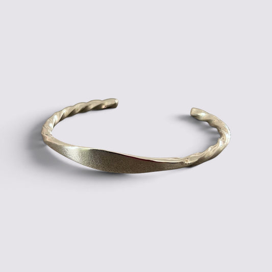The Fashion Jewels sterling silver open cuff bracelet with a polished twisted metal texture
