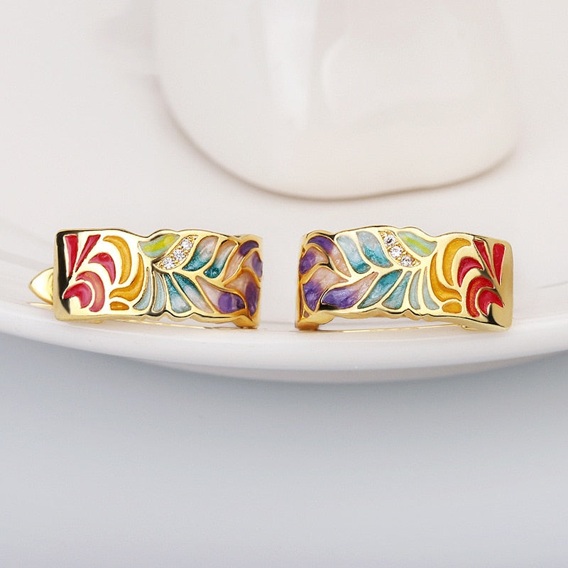 Exquisite 925 sterling silver earrings in gold tone with hand enameled multi-color leaves.